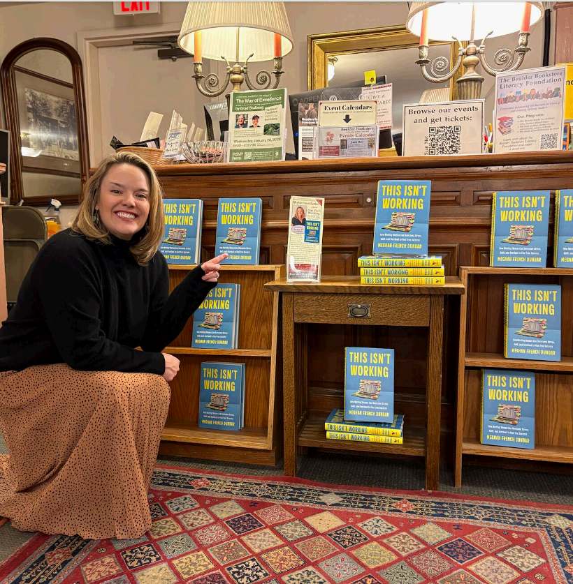 Meghan French Dunbar beside a full display of her book at Boulder Book Store