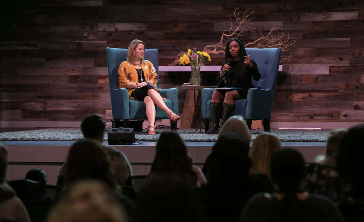 Meghan in conversation on stage with an audience