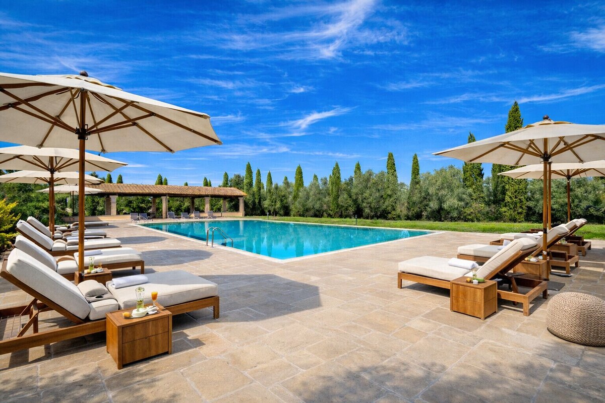 The villa pool lined with cypress trees