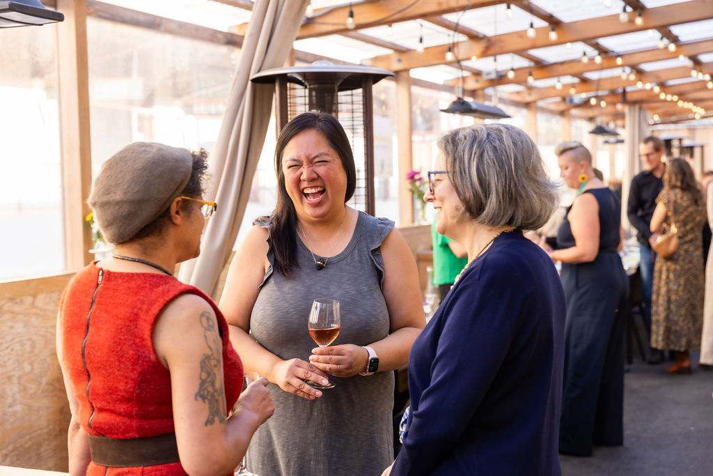 Guests laughing over dinner
