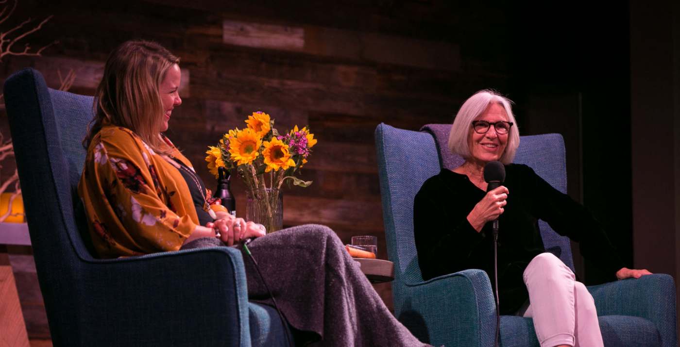Meghan on stage with a guest speaker