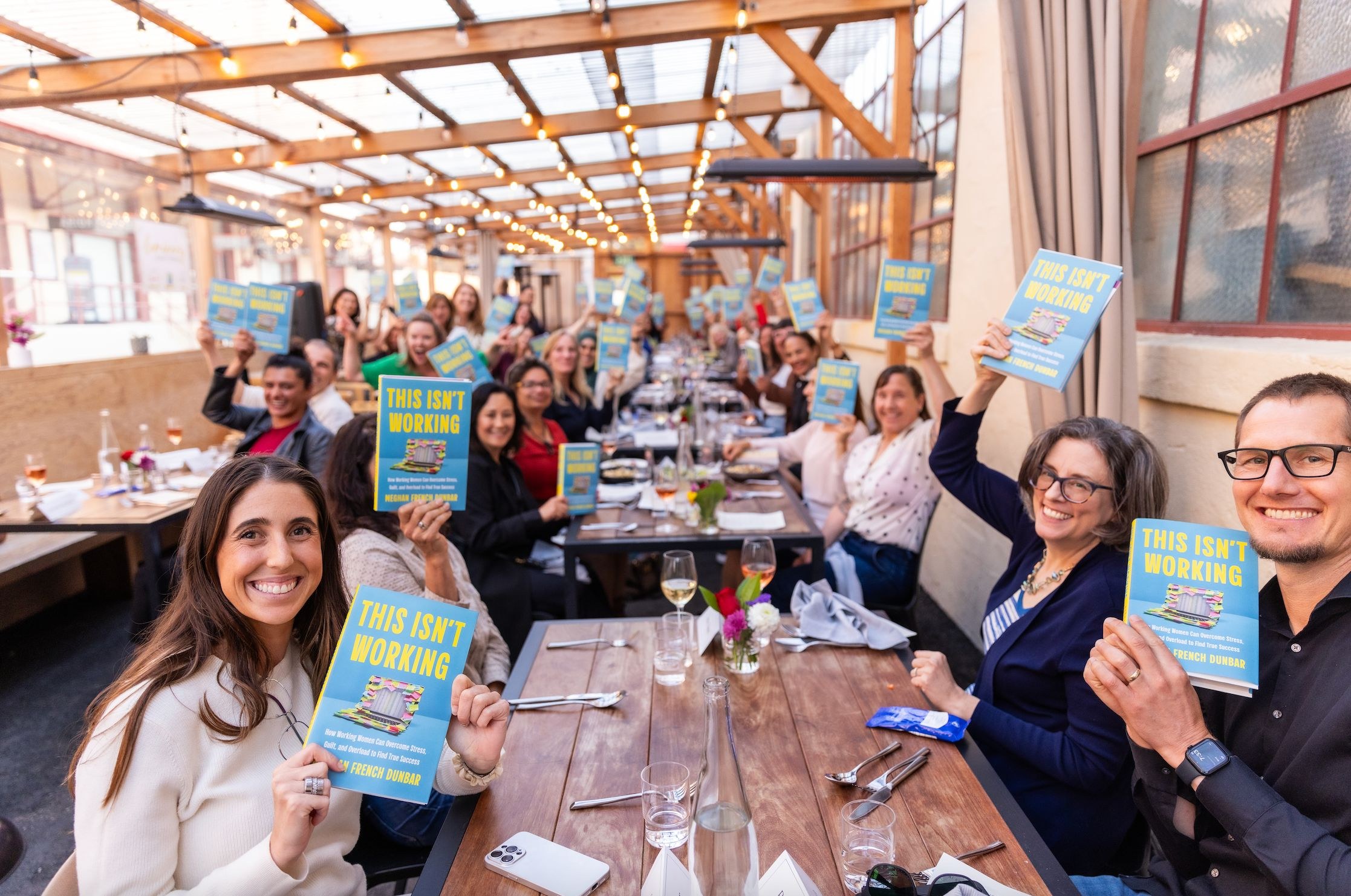 A long table of readers raising This Isn't Working